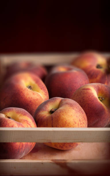 Peaches fresh colorful arrangement in wooden box and dark background