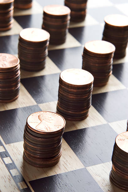 istock Stacks of pennies on a checkered board 95553144