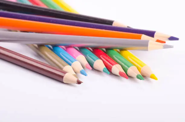 colorful color pencil stacked on white background ideal for back-to-school and education concept