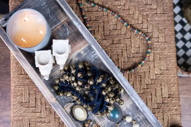 Tealights and other rustic items decorated on a wooden tray.