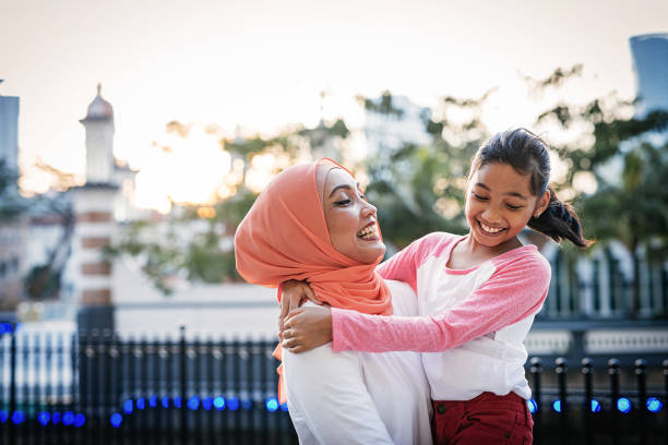 istock Malaysian mature woman with daughters after school 955541896