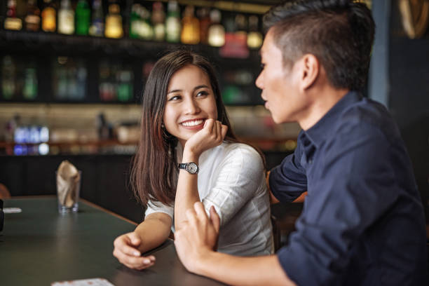istock Multi ethnic couple waiting for the drink in the bar 955548818