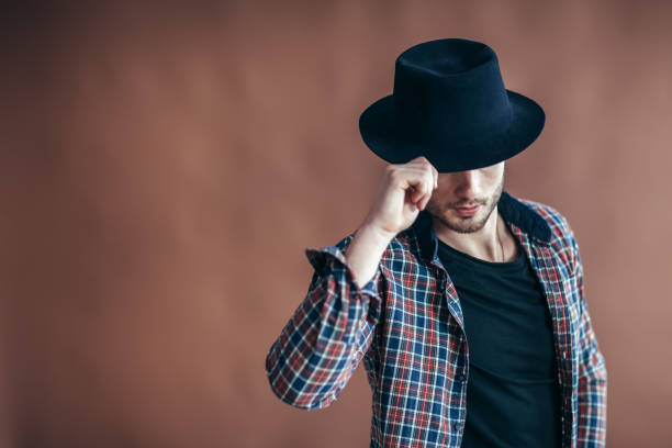 istock Young hipster man wearing hat posing with copy space 955549232