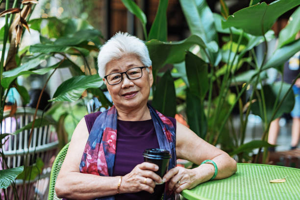 istock Senior woman drinking coffee in cafe 955551396