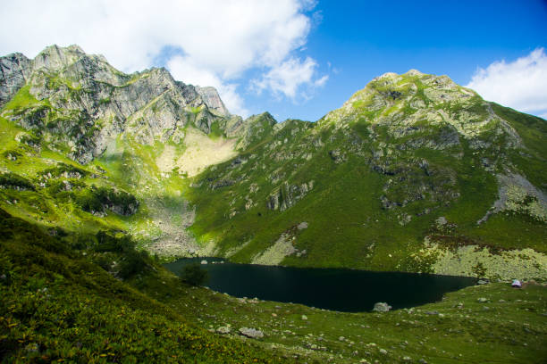 istock Clear lake among mountains in summer day 955552070