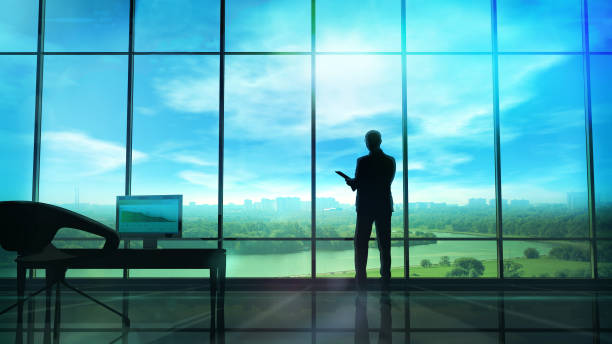 istock Men in the huge office in front of large windows 955552362