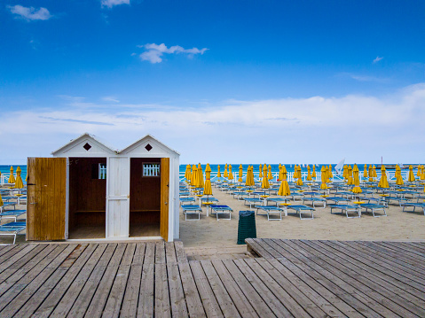 Photo taken at Mondello Beach located near Palermo, Sicily.  Two beach cabin and empty umbrellas on the beach.