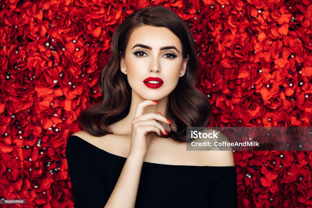 Portrait of a beautiful woman standing behind floral pattern Women Stock Photo