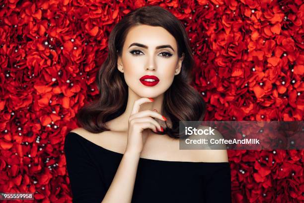 Portrait Of A Beautiful Woman Standing Behind Floral Pattern Stock Photo - Download Image Now