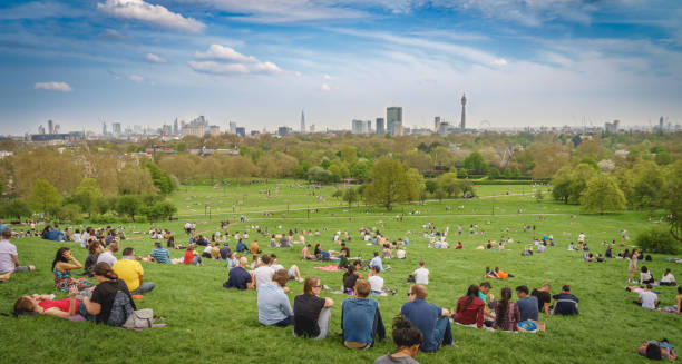 panoramablick auf london stadtbild von einem überfüllten primrose hill park an einem sonnigen frühlingstagen nachmittag gesehen. - people togetherness group of people editorial stock-fotos und bilder