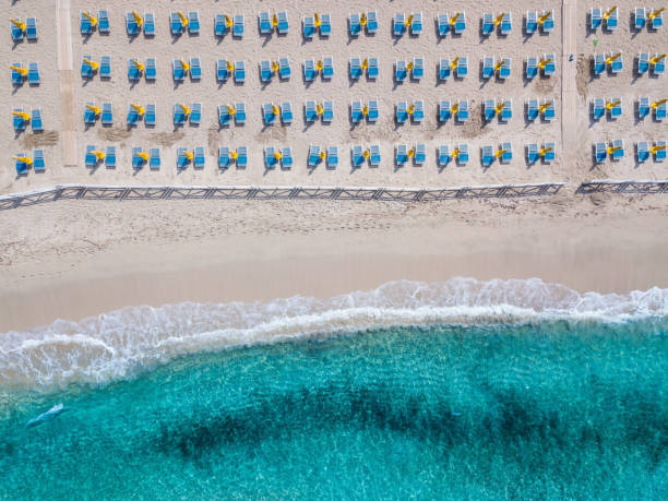 Mondello Beach Aerial view of Mondello Beach located near Palermo, Sicily.  Many umbrellas on the beach. beach umbrella aerial stock pictures, royalty-free photos & images