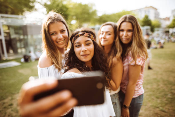 istock friends take a selfie in the park 955569392