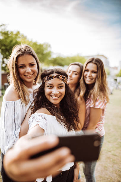 istock friends take a selfie in the park 955569400