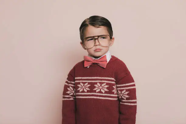 Photo of Young Ugly Christmas Sweater Boy is Sad