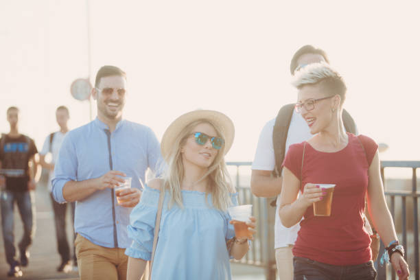 istock Group of tourists walking around with local beer 955576316