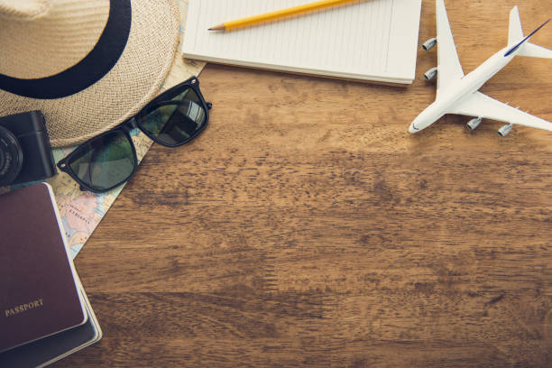 istock Traveling gadgets on wood table background, top view border design with copy space 955576378