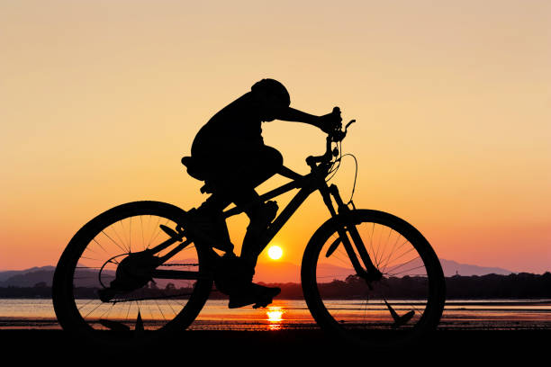istock People cycling at the beach twilight time 955586170