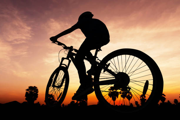 istock People cycling at the hill mountain twilight time 955586336