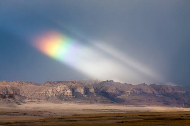 istock rainbow in the sky after storm among the high mountain 955586870