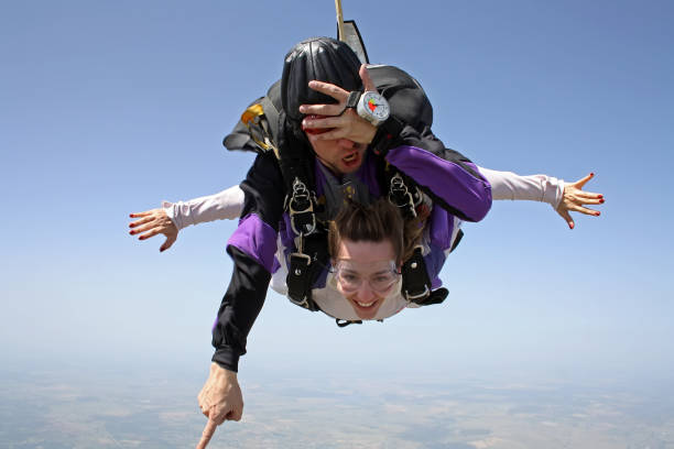 istock Skydiving tandem pretty woman 955589498
