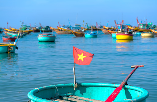 Mui Ne, Vietnam - April 22, 2018: Fishing village and traditional fishing boat with hundreds boats anchored in beautiful stream. This is  bay for boats avoid rainy season storms in Mui Ne, Vietnam