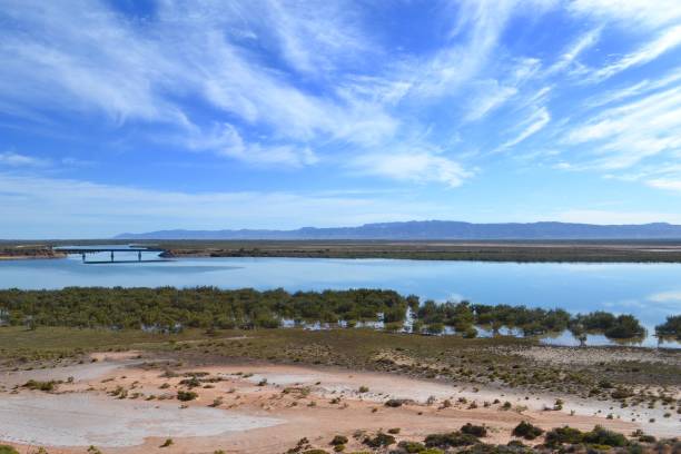 Sweeping view of outback river near Port Augusta with big sky and Flinders Ranges in background stock photo
