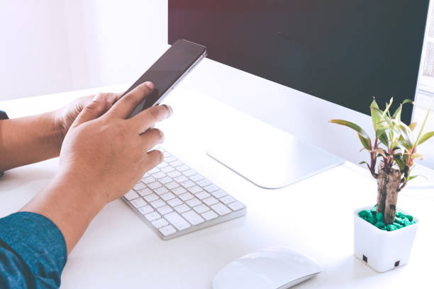istock Businessman hands using cell phone at office desk. man's hands using smart phone 955599592