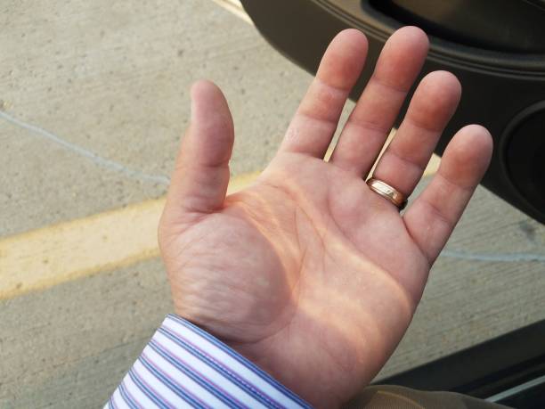 istock man's hand with gold ring and car door 955603408