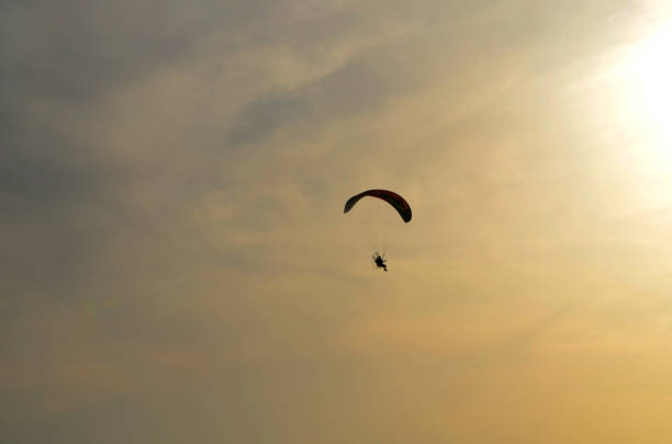 istock motoparaplane against the sky and the sun. 955604026