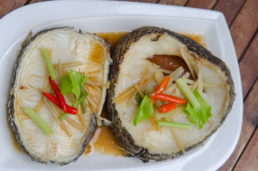 Steamed Snow Fish with Soy Sauce and Ginger in the white plate