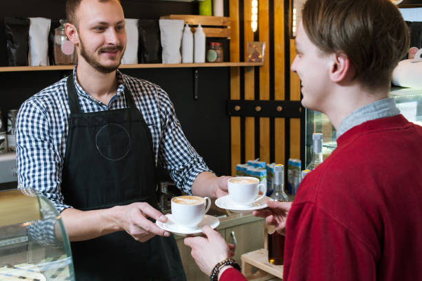 istock barista serve cup client hipster man coffee shop 955615872