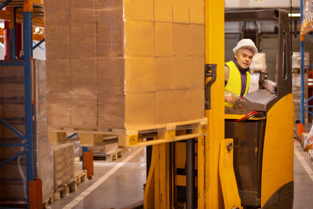 istock Nice smart man working in the storehouse 955620102