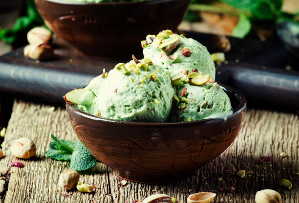 istock Pistachio ice cream with nuts, decorated with mint leaves 955624892