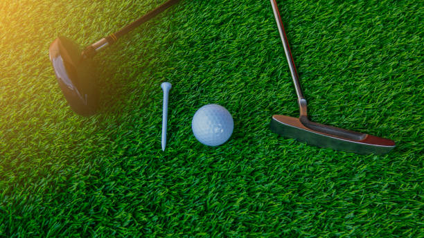 istock Golf club and golf ball and tee on green grass 955628876