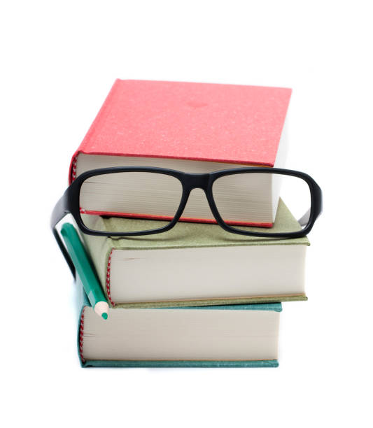 istock Books and glasses isolated on white background 955645554