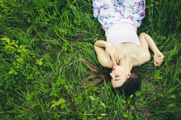 Caucasian girl in white dress lying