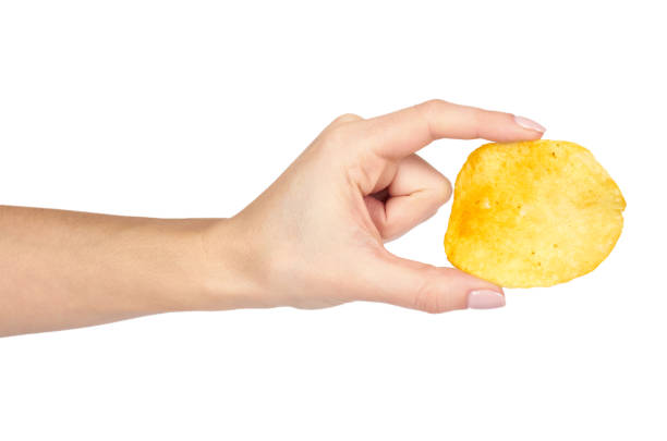 istock Golden potato chip with hand, isolated on white background 955649896