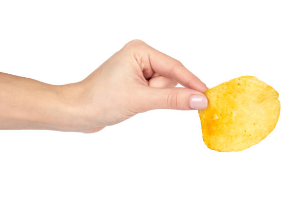 istock Golden potato chip with hand, isolated on white background 955649928