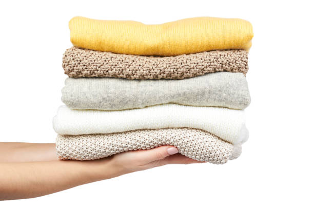 istock Pile of foldet cloth with hand, isolated on white background 955649970