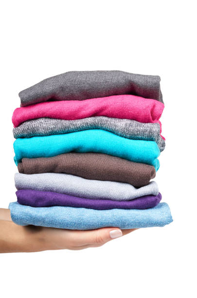 istock pile of multi color fabric texture with hand, wool cloth isolated on white background 955650764