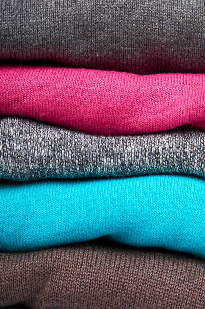 istock pile of multi color fabric texture, wool cloth isolated on white background 955650796