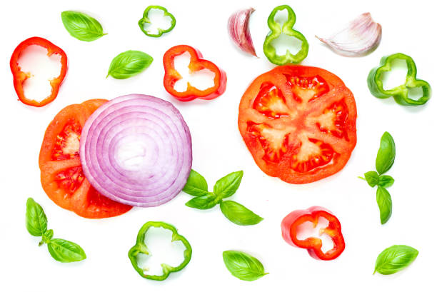 istock Creative layout with  Fresh vegetables, herbs and spices isolated on white background. Food pattern with red pepper, onion, tomatoes and basil leaves. Top view