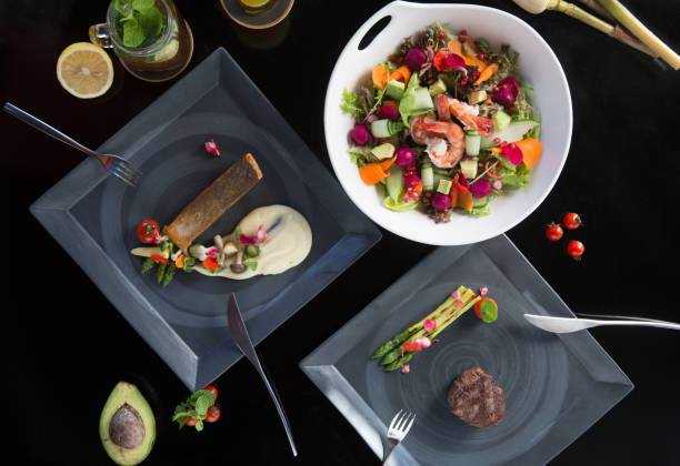 istock Various different tasty dishes plates on dark background. Fish, steak, salad 955656006