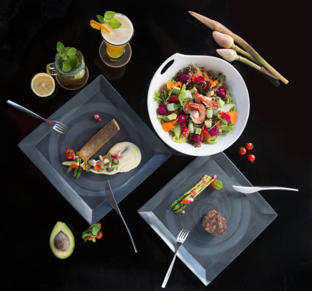 istock Various different tasty dishes plates on dark background. Fish, steak, salad 955656046