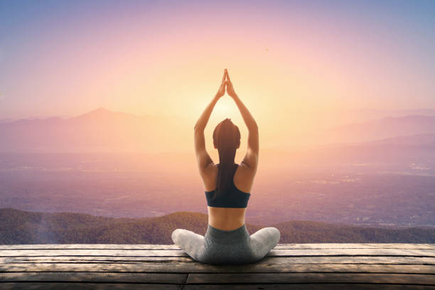 istock Young woman is practicing yoga at mountain 955656136