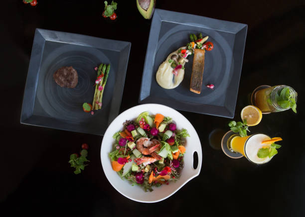 istock Various different tasty dishes plates on dark background. Fish, steak, salad 955656596