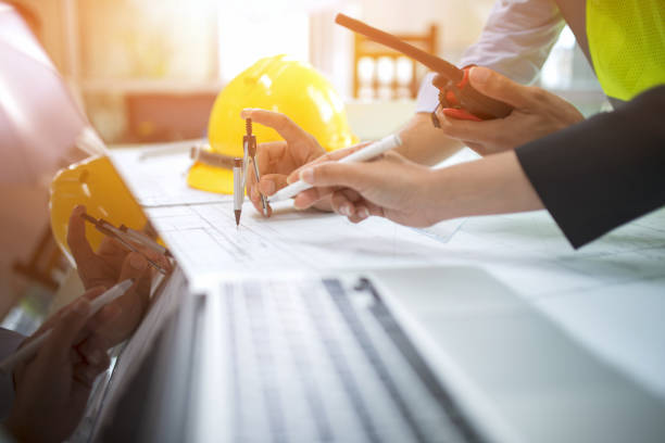 istock Engineer asia man and woman discussing about building plan for construction at job site, Selective focus 955656986