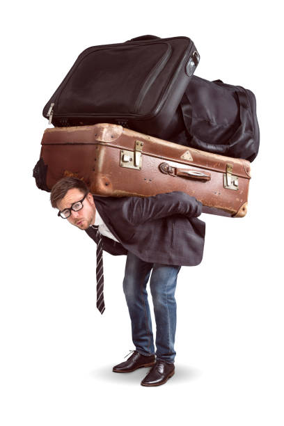 Man with heavy baggage A man is straining under a heavy load of luggage. The seize of luggage is comically large. excess stock pictures, royalty-free photos & images