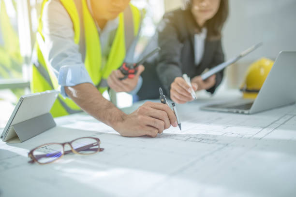 istock Engineer asia man and woman discussing about building plan for construction at job site, Selective focus 955661274