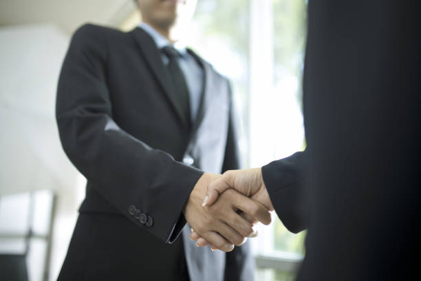 istock Business handshake and business people 955661316